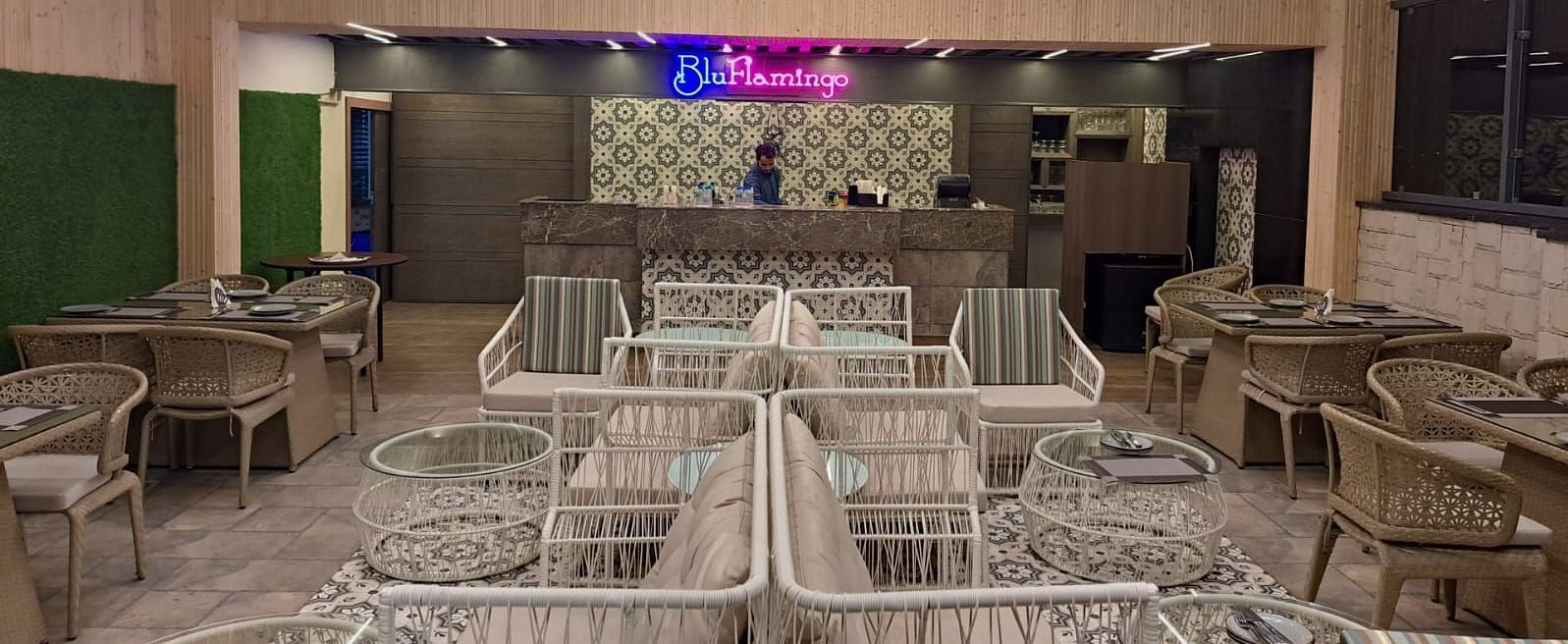 Rooftop lounge featuring illuminated Blu Flamingo logo with ambient lighting at BluSalzz Residence, Amritsar